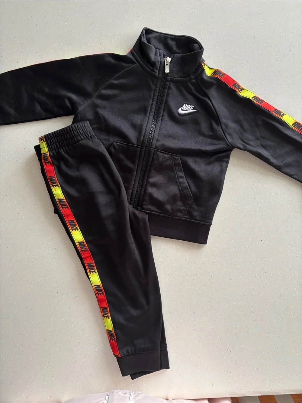 Nike Black Kids Track Set with Red and Yellow Stripe